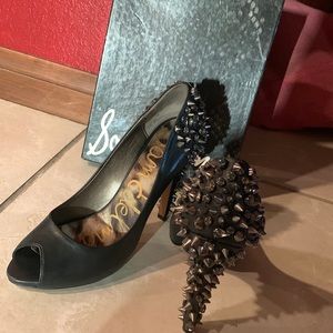 Black, leather open toe shoes. Studs in the back.